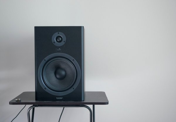 A black speaker on a table.